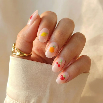 Sheer nude soft gel press-ons with mixed fruit art: lemon, orange, cherries, strawberry