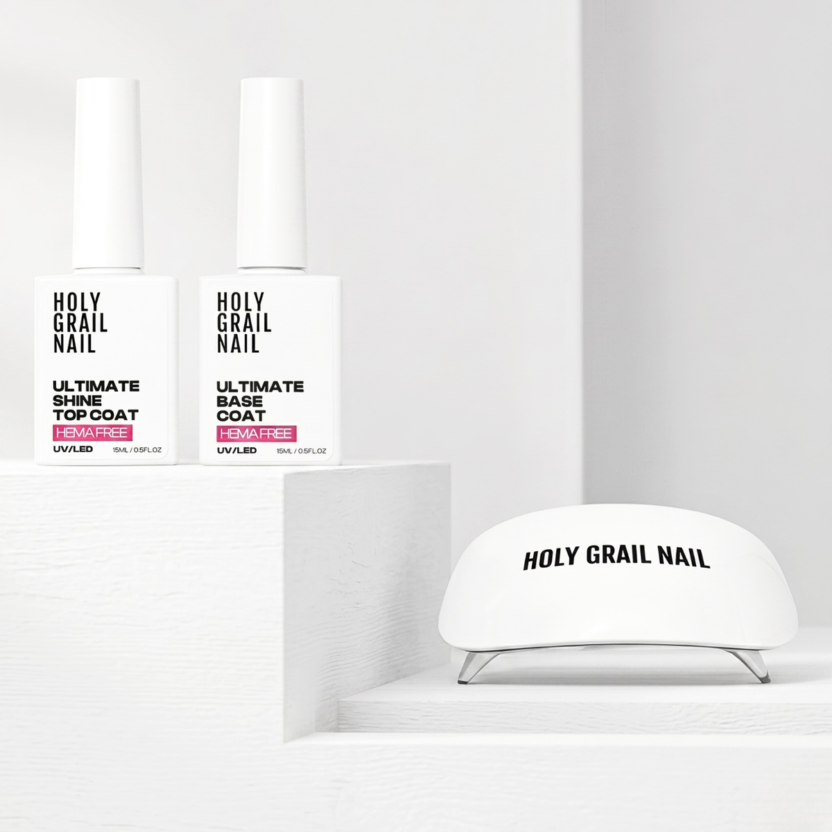 Holy Grail Nail UV/LED gel top and base coat bottles with white nail lamp