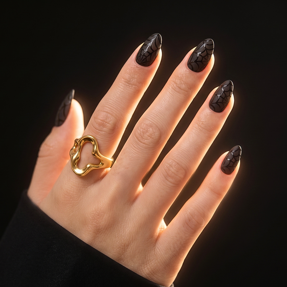 Black soft gel press-on nails, short almond shape, with glossy spiderweb design.