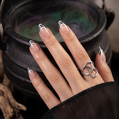 Short almond soft gel press-ons, nude nails with black and white striped French tips