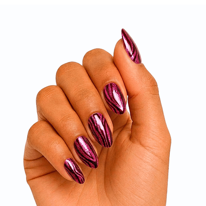 Semi-cured gel wraps in shimmering magenta with black zebra-stripe pattern, glossy finish