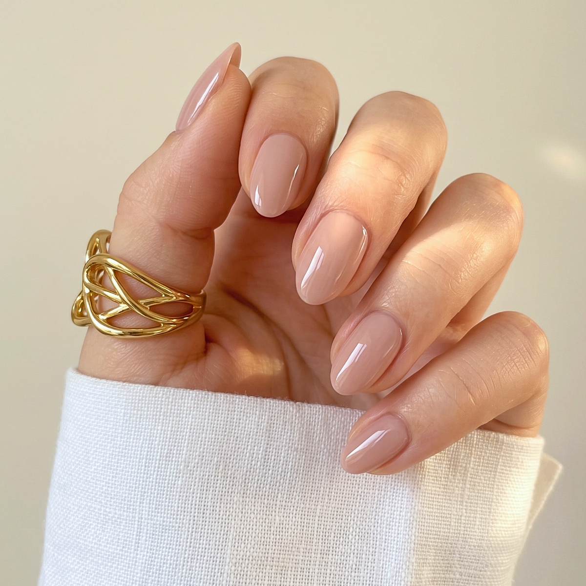 Soft gel press-ons in glossy nude-beige, extra short natural almond shape
