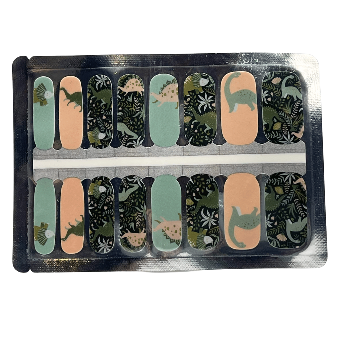 Nail wraps with dinosaur prints on sage green, peach and dark green jungle-leaf backgrounds