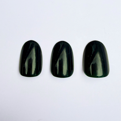 Dark hunter green glossy press-on nails, short oval shape, solid high-shine finish