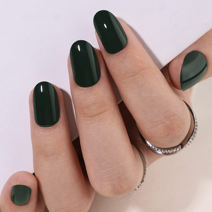 Dark forest green glossy soft gel press-on nails, short oval shape, solid colour