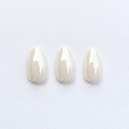 Sheer pearly white almond press-on nails with glossy, high-shine finish