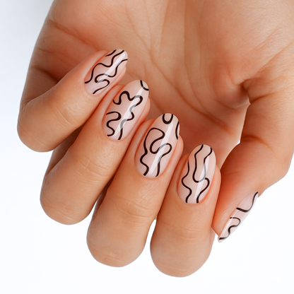 Sheer nude nail wraps with abstract black squiggly line art, glossy finish