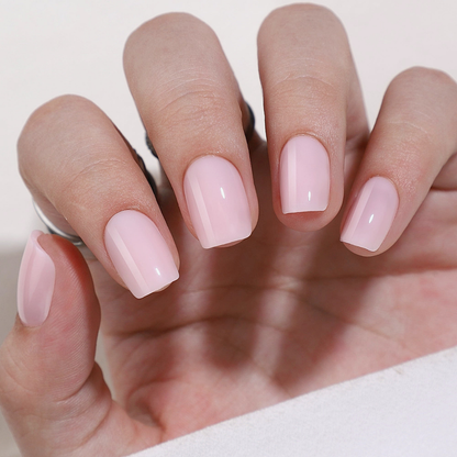 Soft gel press-on nails in sheer milky pink, short square shape with glossy finish