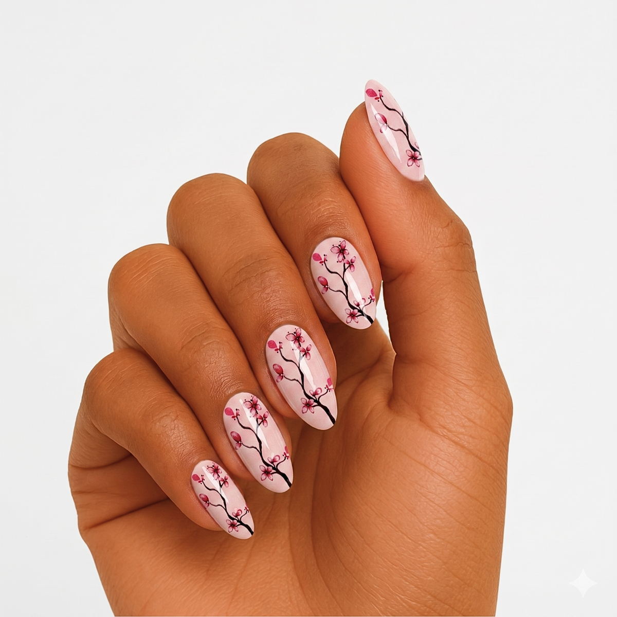 Sheer pink glossy semi-cured gel nail wraps with cherry blossom branch design, almond shape