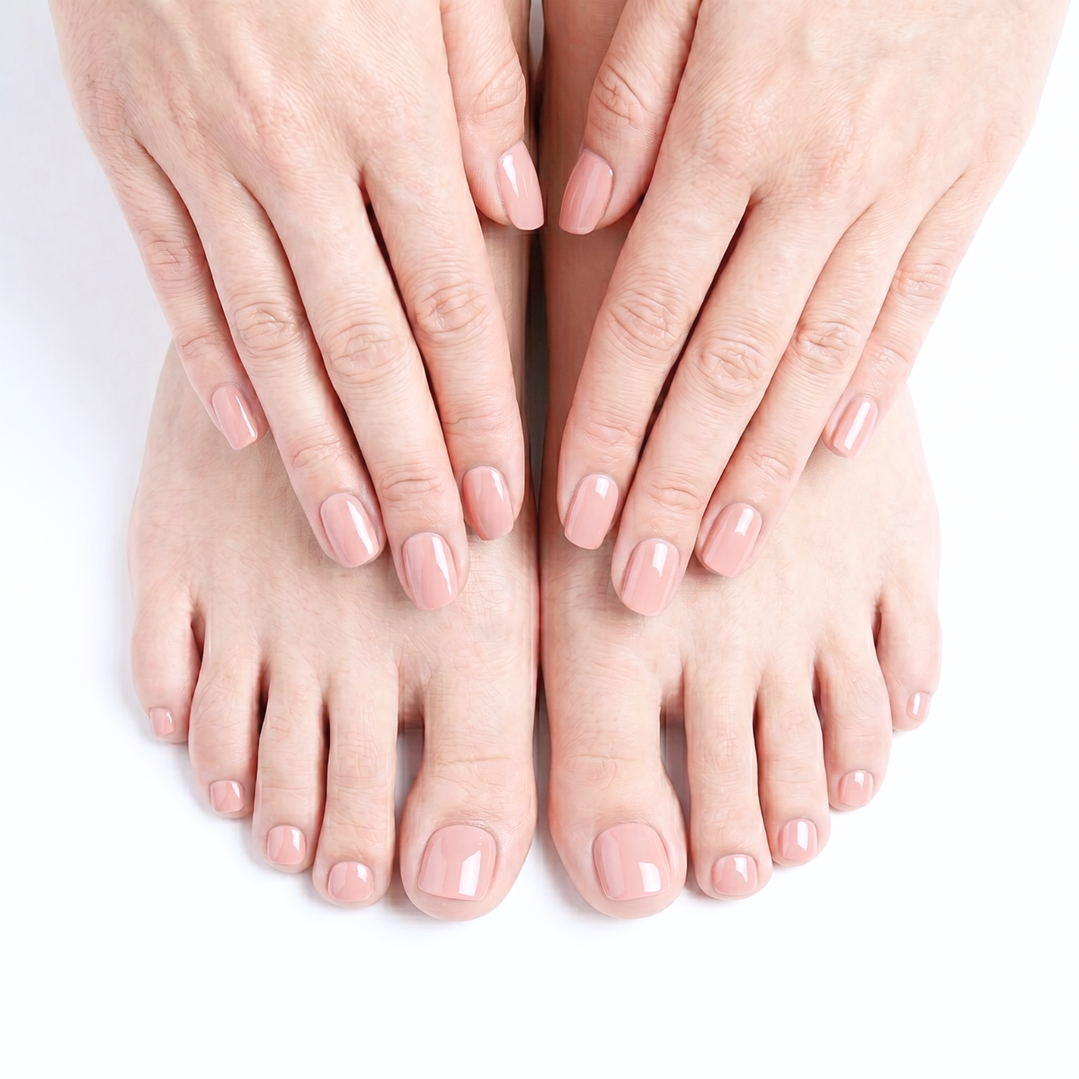 Nude pink glossy semi-cured gel nail wraps shown on fingers and toes