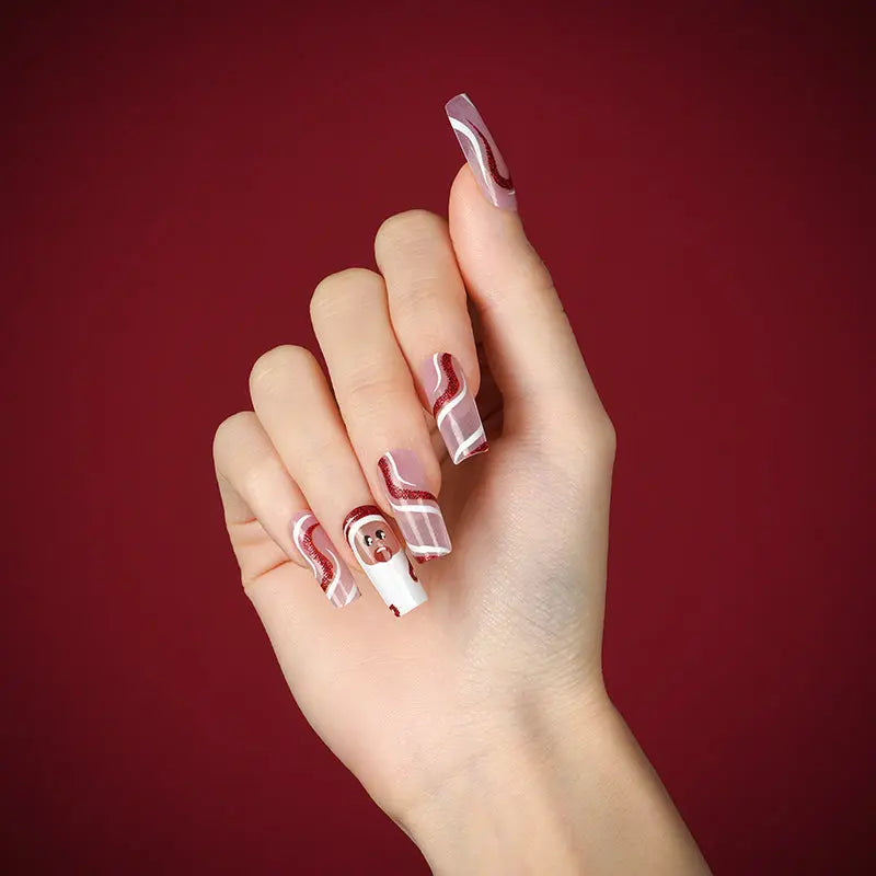 Long square nail wraps, nude base with burgundy swirls, white tips and Santa design.