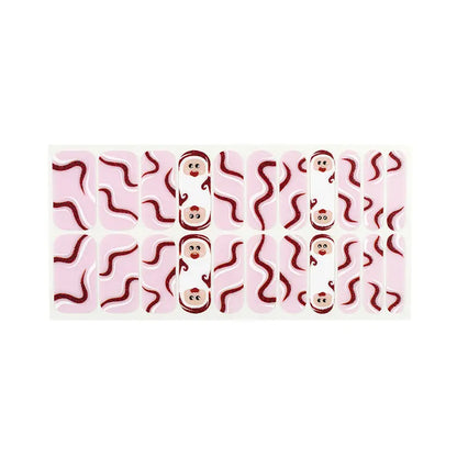 Pink nail wraps with swirling red lines and cartoon Santa face accents, wide fit