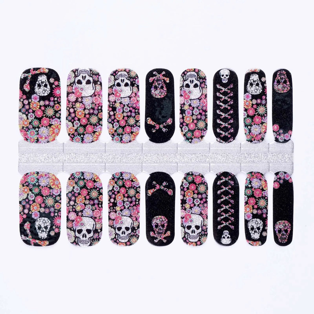 Black nail wraps with sugar skulls, crossbones, and pink floral glitter print