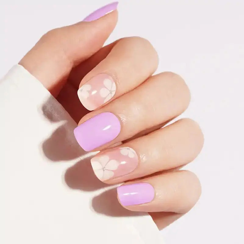 Semi-cured gel nail wraps in glossy lilac with sheer nude white floral accent nails
