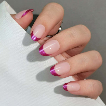 Soft gel press-ons, sheer nude base with glossy metallic magenta French tips, short oval