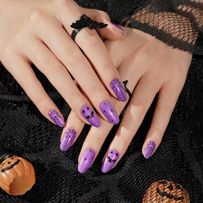 Purple nail wraps with black spiderweb, jack-o'-lantern face and star Halloween designs