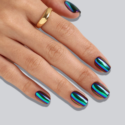 Short square soft gel press-on nails with oil-slick chrome finish in blue, green and purple tones.