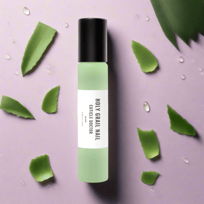 Green aloe cuticle oil pen surrounded by fresh aloe vera leaves