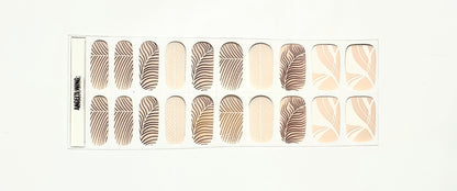 Complete set of champagne gel nail wraps featuring gold feather and geometric nail art
