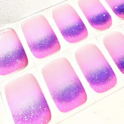 Detailed view of sparkly purple pink gradient gel nail wraps with glitter ombre design