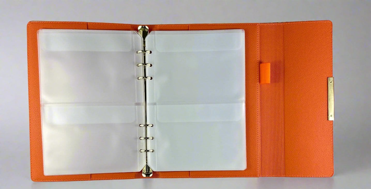 Orange nail wrap storage binder open showing clear plastic sleeves for organising nail art supplies