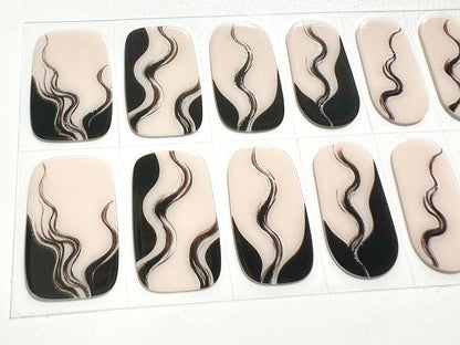 Close-up of black and white marbled smoke pattern gel nail wraps sheet