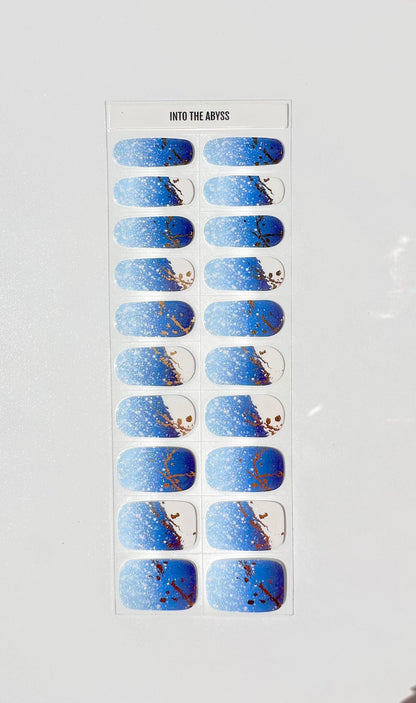 Into The Abyss semi-cured gel nail wraps featuring blue gradient with gold marble patterns on sheet