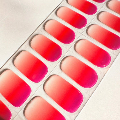 Coral pink ombre gel nail wraps strip showing gradient semi-cured nail art
