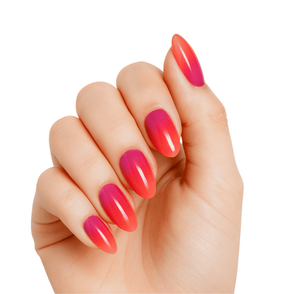 Glossy coral pink ombre gel nails with gradient finish on hand