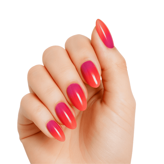Glossy coral pink ombre gel nails with gradient finish on hand