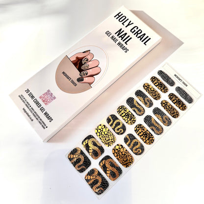 Black and gold snake scale gel nail wraps packaging with textured serpentine patterns