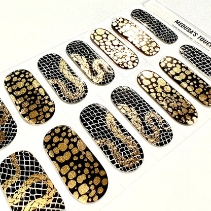 Sheet of black gel nail wraps with gold metallic snake scale and mesh patterns