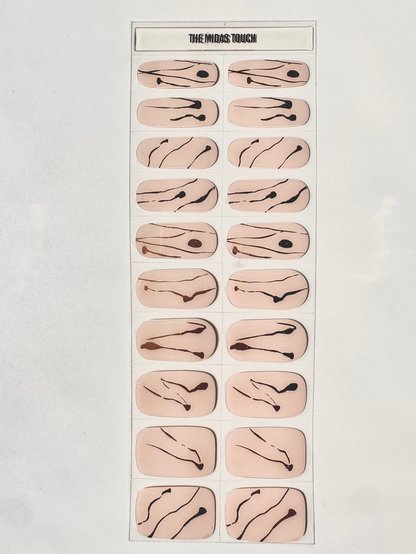 Complete sheet of nude gel nail wraps featuring gold and brown marble swirl designs