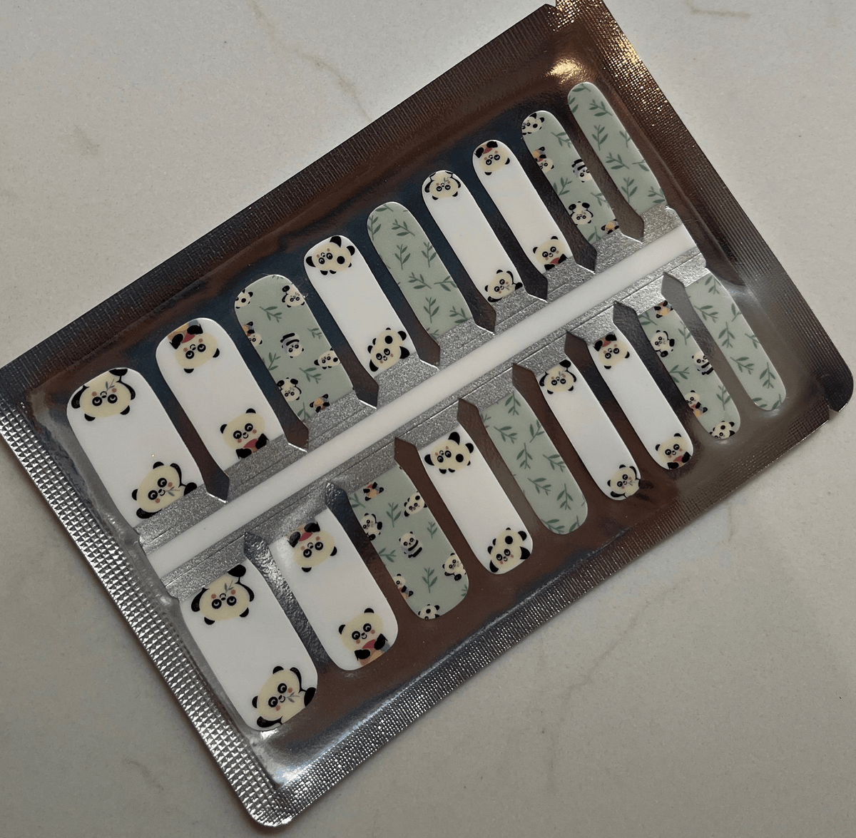 Complete set of panda kids nail wraps showing mint green and white kawaii animal designs