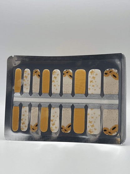 Kids nail wraps with yellow sunflower and butterfly patterns in packaging