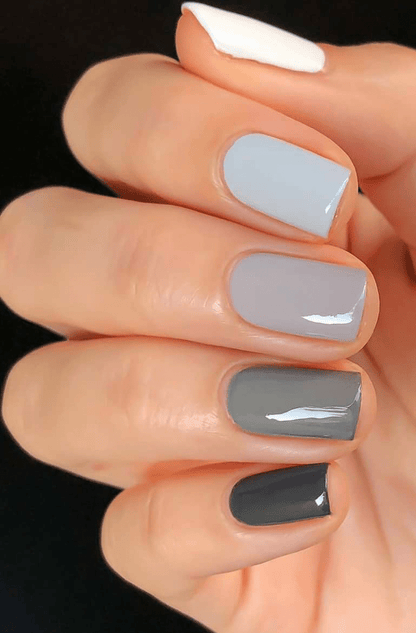 Grey ombre nail wraps on hand showing gradient from light to dark shades