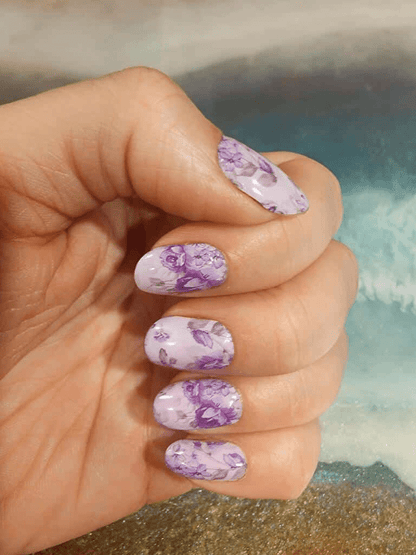 Lavender rose nail wraps on fingertips displaying floral at-home manicure