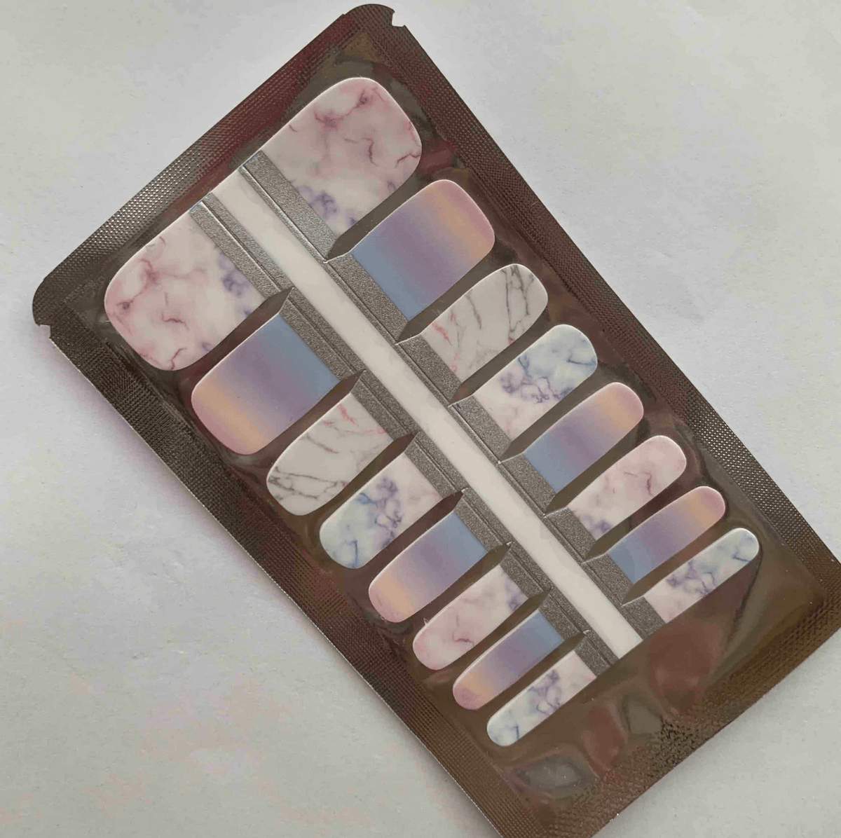 Purple marble ombre pedicure nail wraps in packaging showing stone pattern design