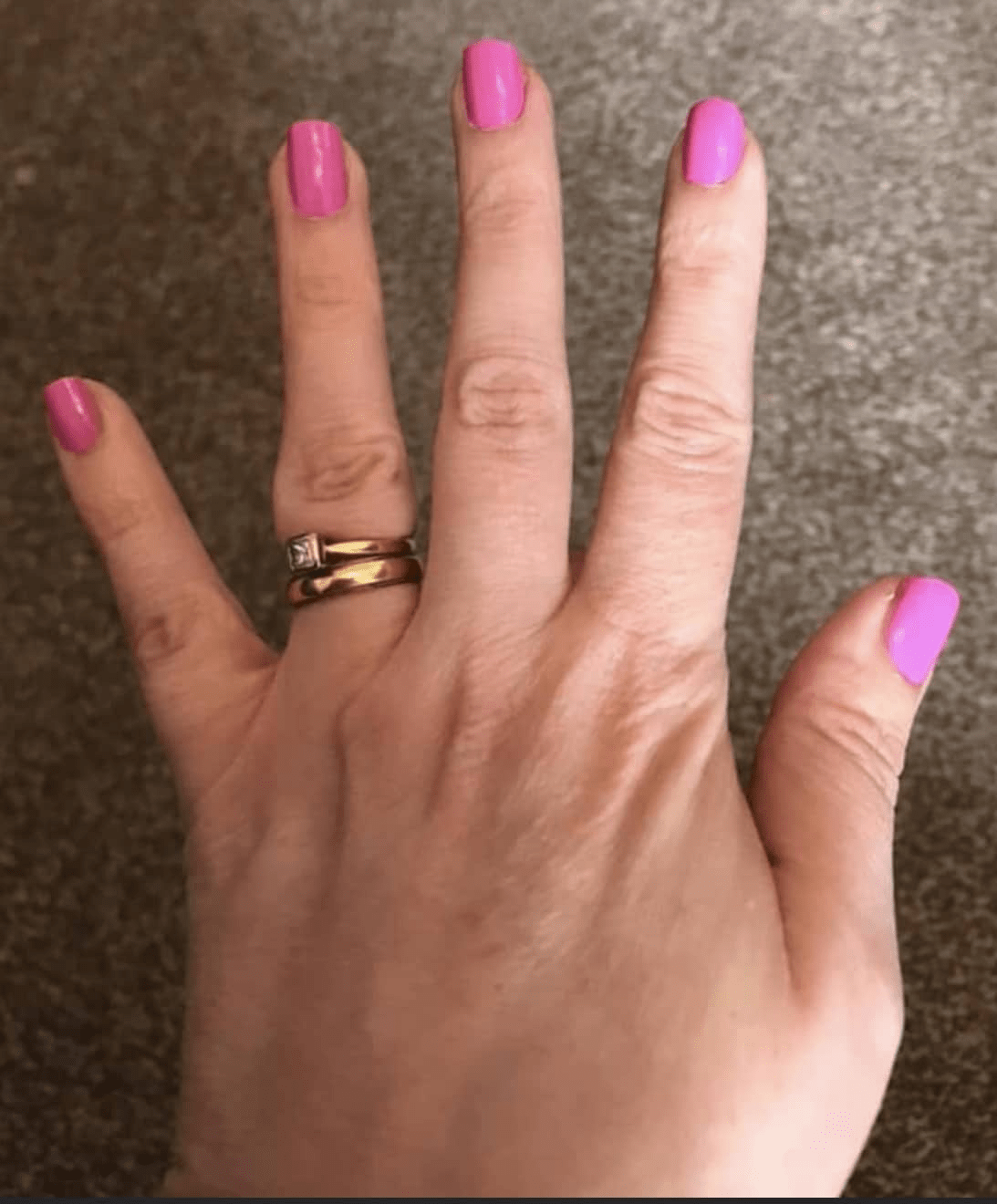 Hot pink glossy nail wraps in a solid colour on short square nails