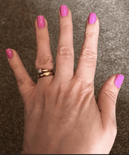 Hot pink glossy nail wraps in a solid colour on short square nails