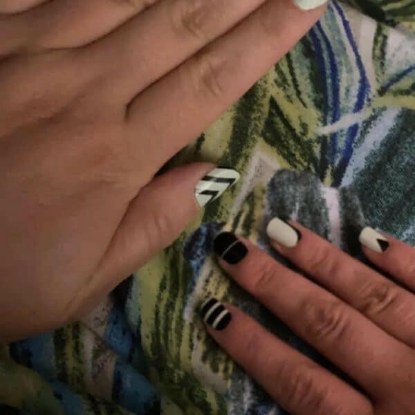 Black and white geometric nail art wraps showing striped designs on fingers