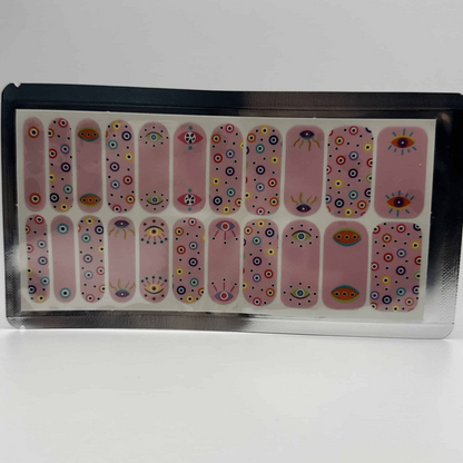 Pink nail wraps with mystical all-seeing eye pattern in wide fit packaging for nail art