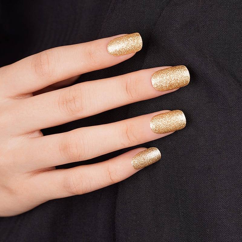 Gold glitter nail wraps in a full-shine finish on squared nail tips