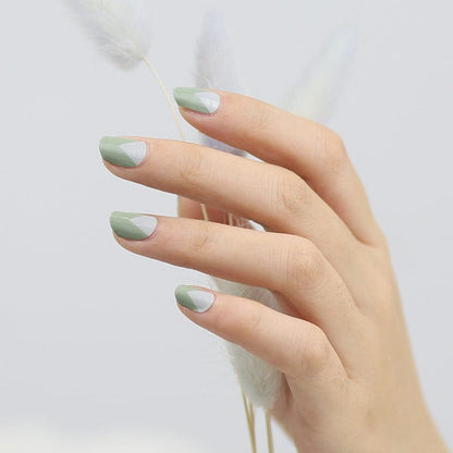 Sage green non-UV nail wraps on hand showing matte finish manicure