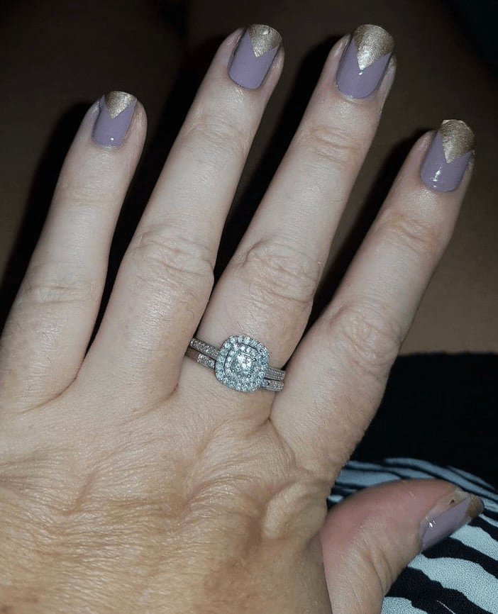 Purple nail wraps with gold chevron pattern applied on hand showing elegant nail art