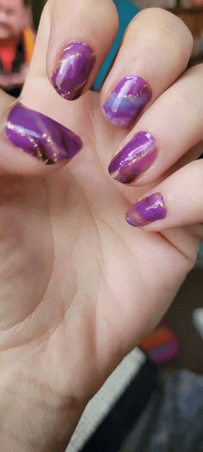 Purple marble nail wraps with gold veining on fingernails at-home manicure look
