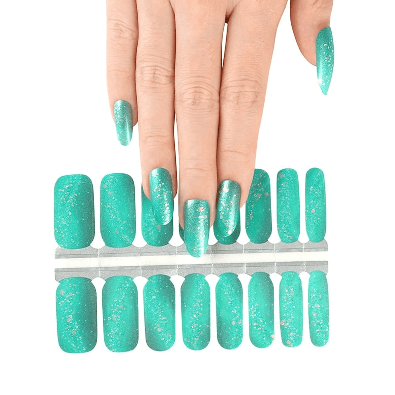 Hand selecting from turquoise glitter nail wrap sheet showing individual wrap sizes