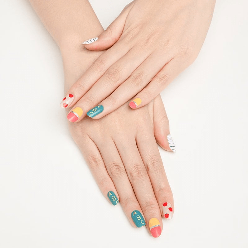 Nail wraps featuring teal chalkboard ABC design, pencil tips, red apples and notebook lines
