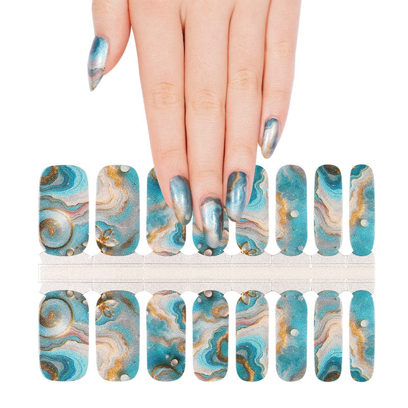 Teal and gold marble-effect nail wraps with swirling agate pattern and pearl accents