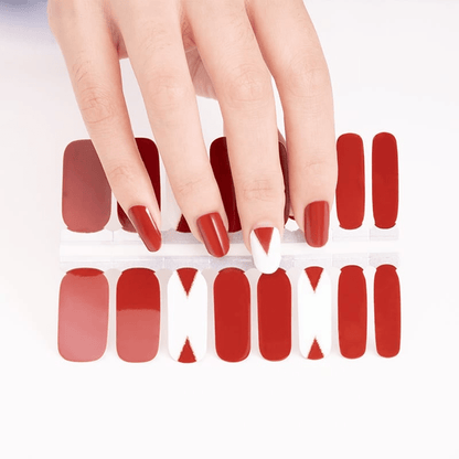 Red matte nail wraps with geometric cutout patterns for at-home manicure